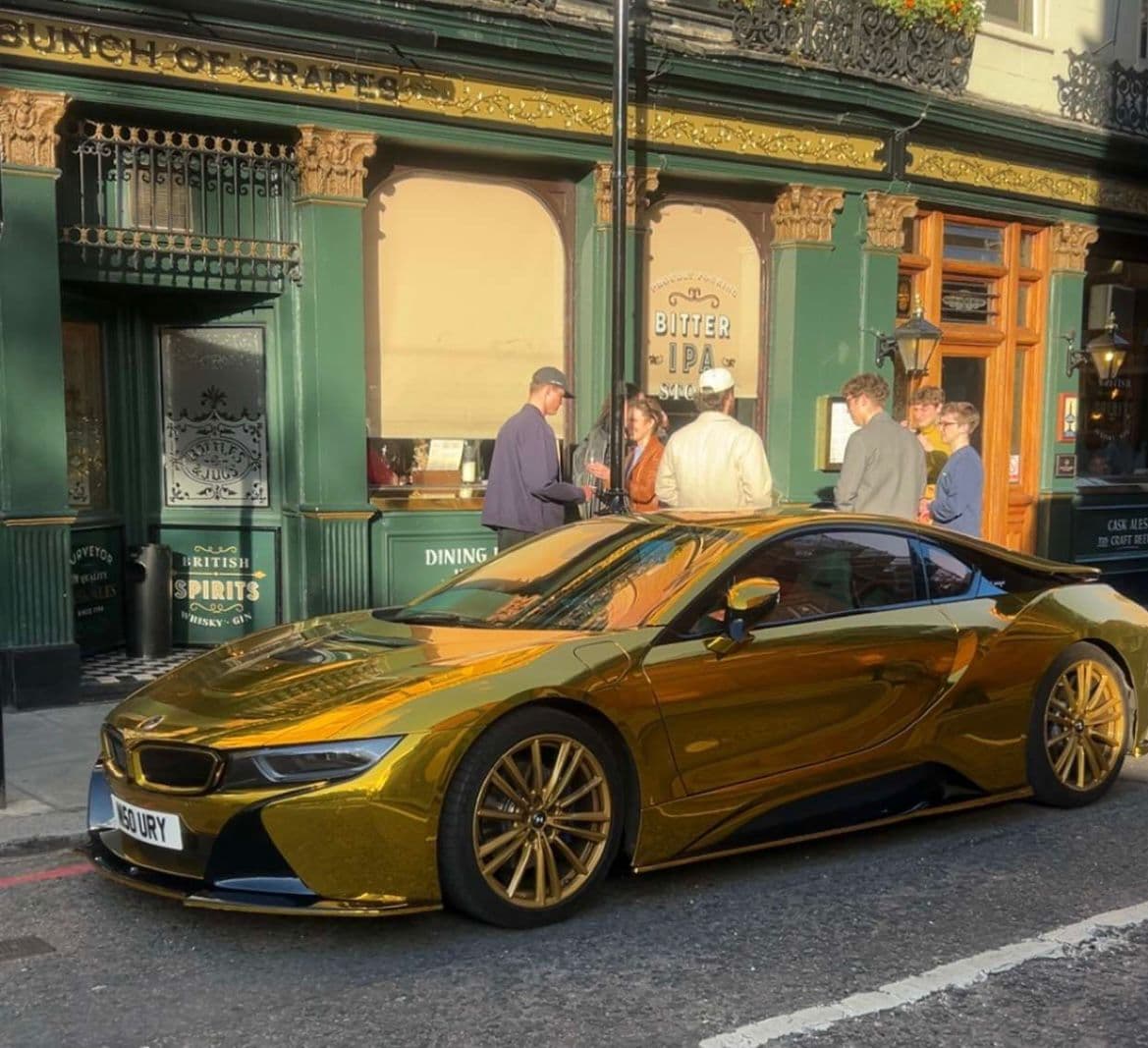 Gold car parked outside a pub