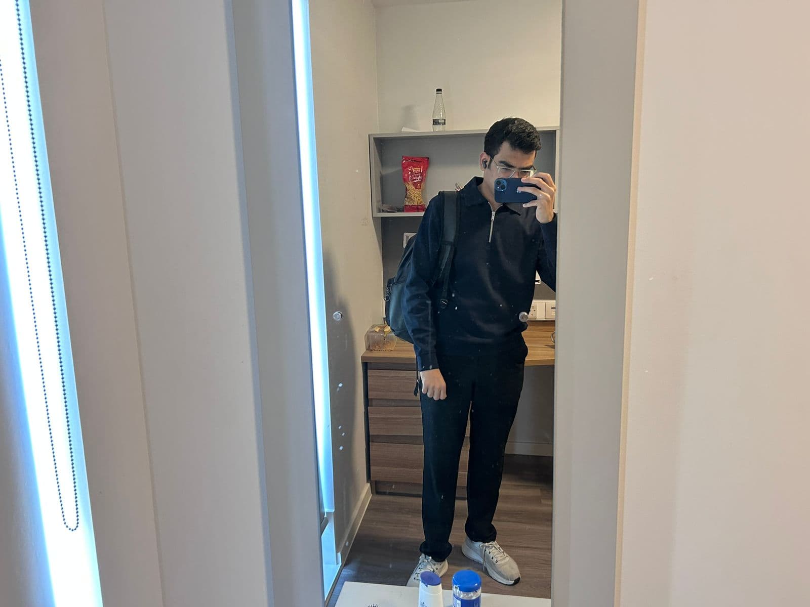Kshitiz taking a mirror selfie in a black outfit